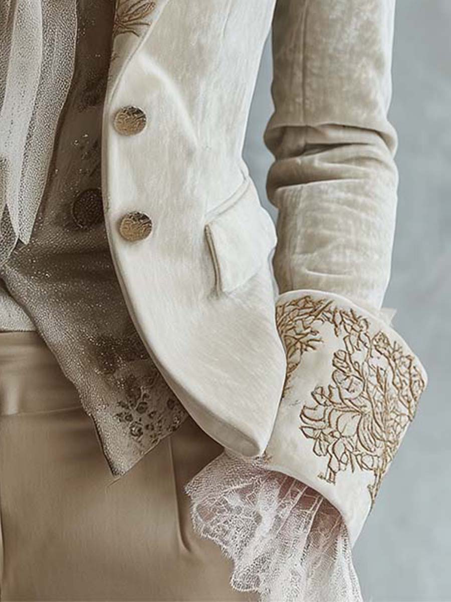 Close-up of the embroidered cuff and two-button front of the ivory blazer