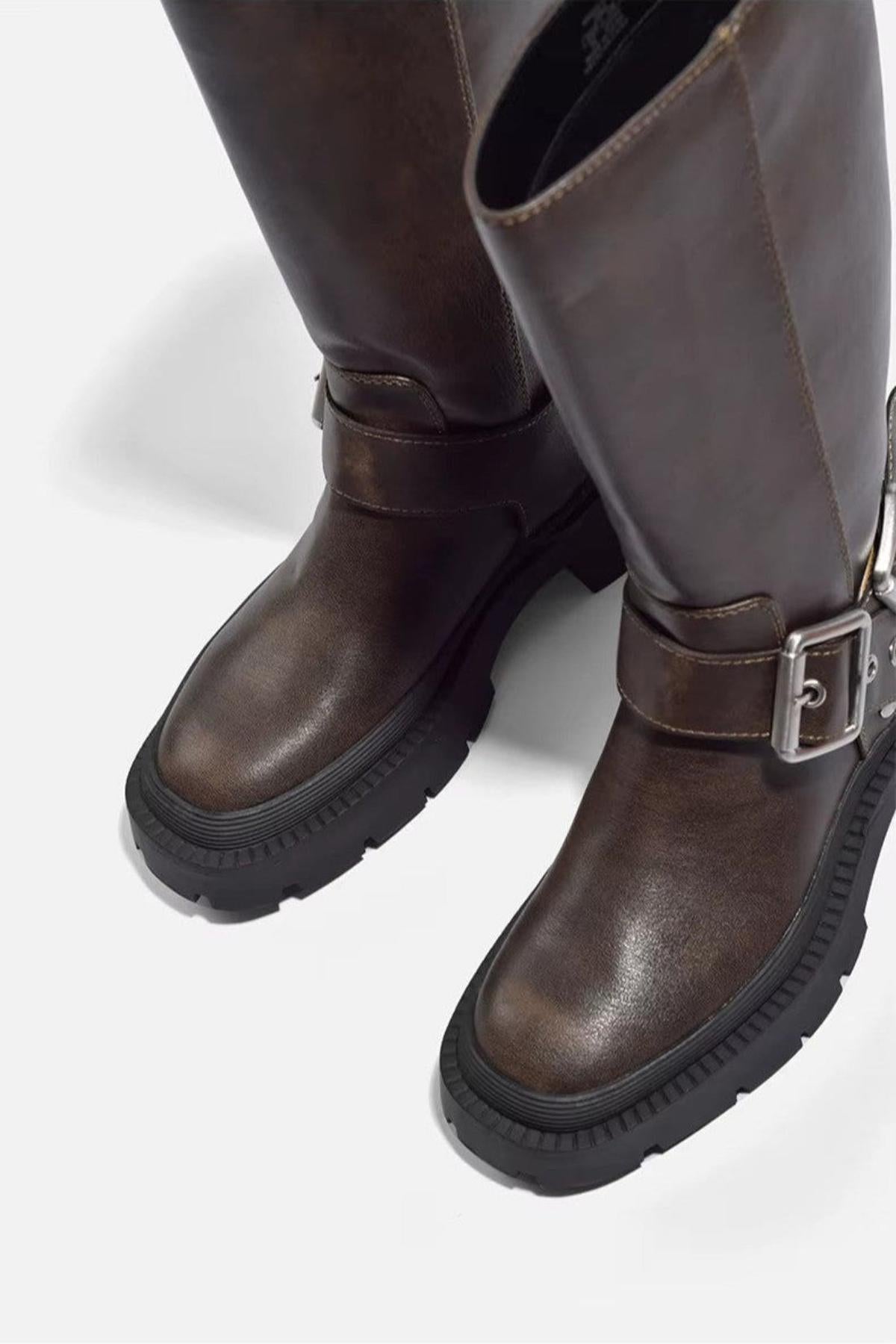 Brown biker boots seen from above, showing the round toe and lug sole edge