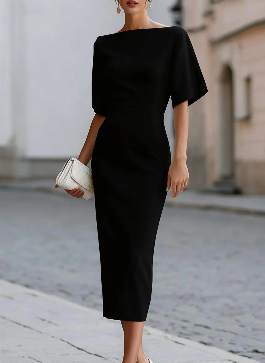Black boat neck midi pencil dress with dolman sleeves and a white clutch