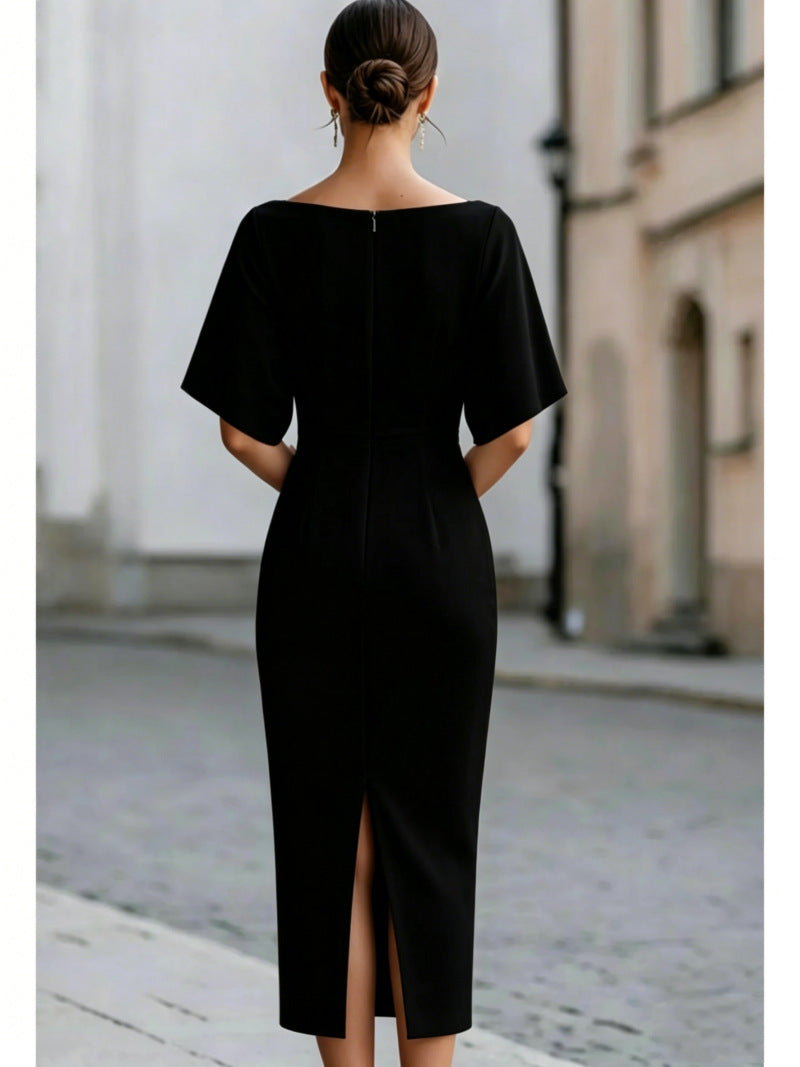 Back of a black midi pencil dress with a center back zip and a back slit