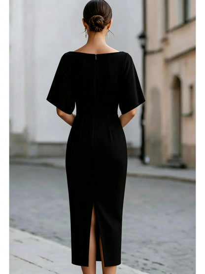 Back of a black midi pencil dress with a center back zip and a back slit