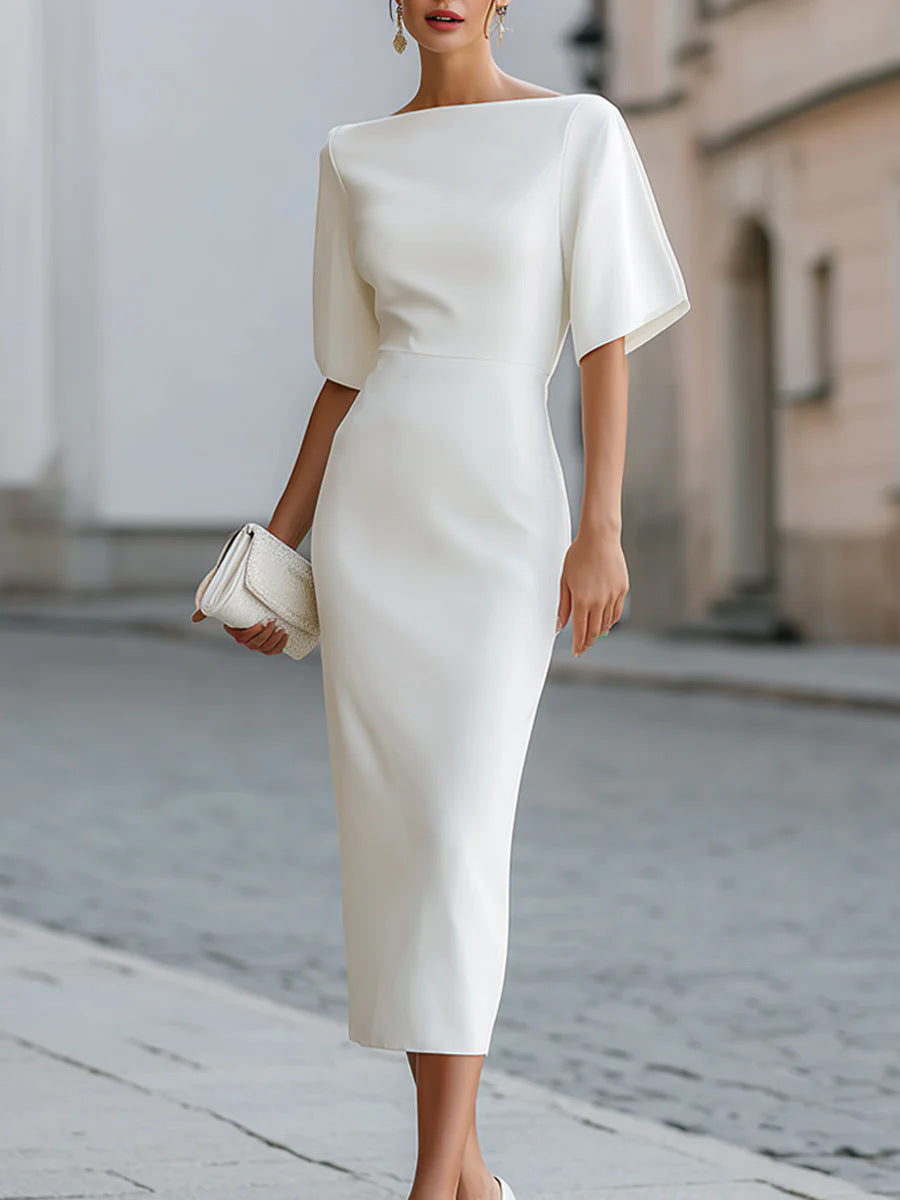 White midi pencil dress with a boat neckline and wide elbow length dolman sleeves