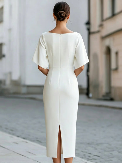 Back of a white midi pencil dress with a center back zip and a back slit