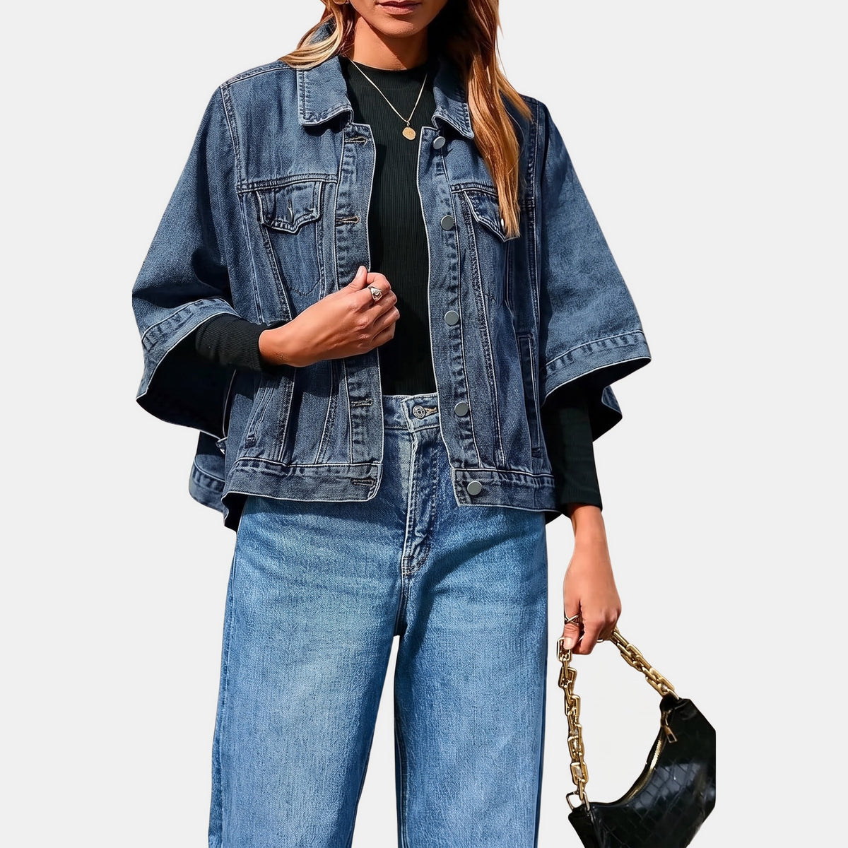 Dark wash batwing denim jacket worn over a black top with wide jeans