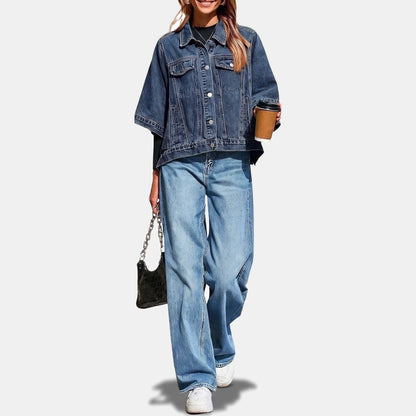 Dark wash batwing denim jacket styled with wide jeans and sneakers