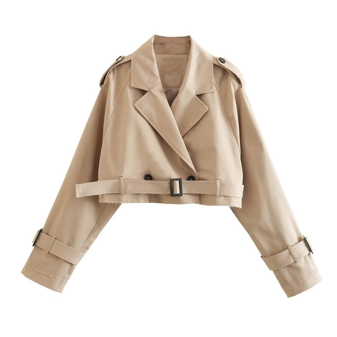 Beige cropped trench jacket with buckled hem belt and notched lapels, front flat lay