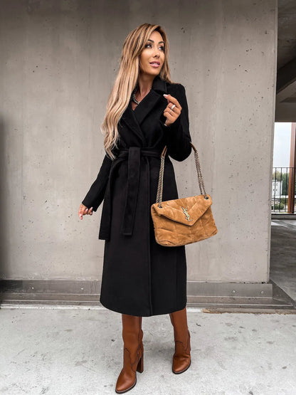 Black belted shawl collar coat worn with brown boots