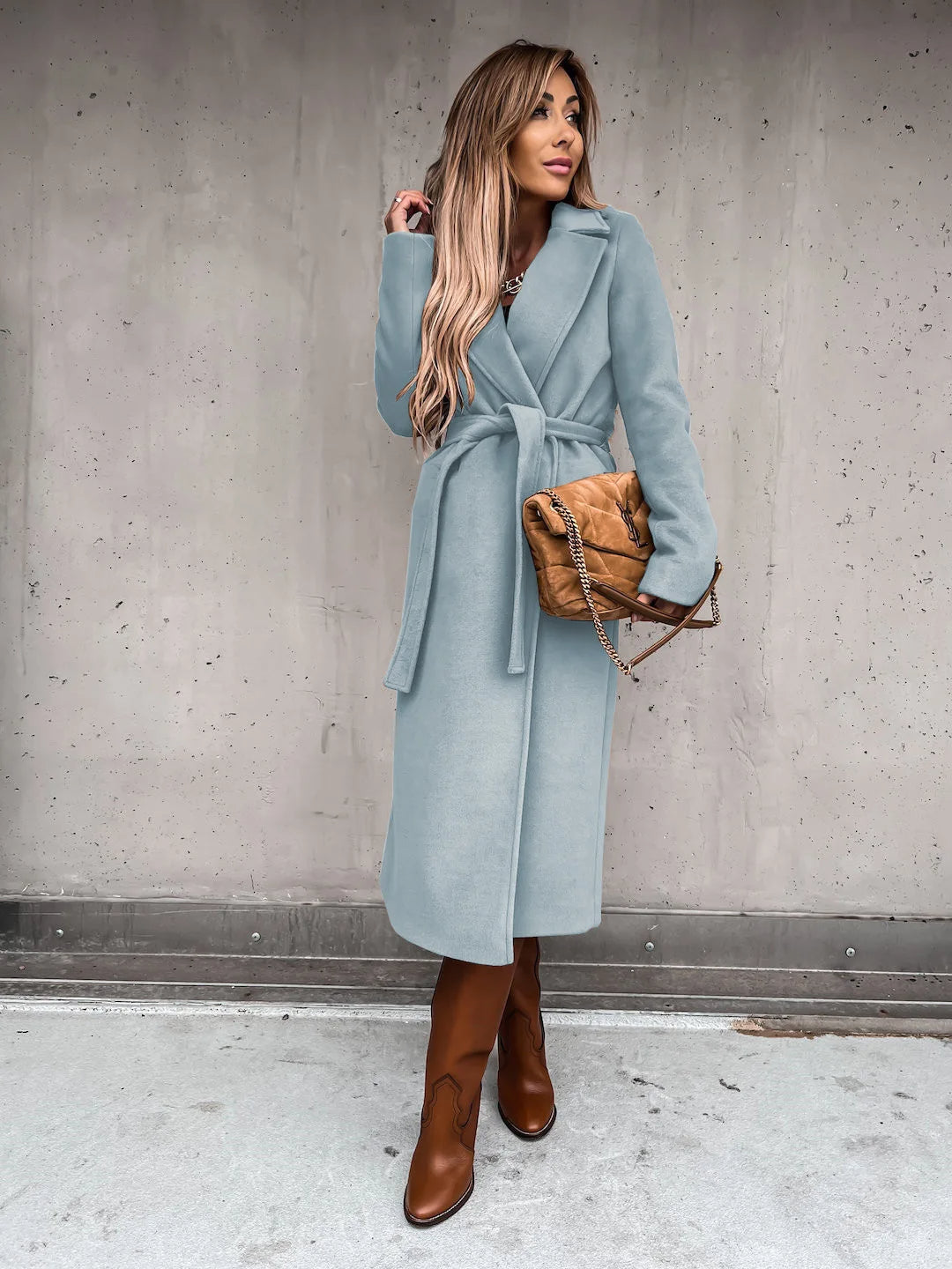 Light blue belted shawl collar coat worn with brown boots