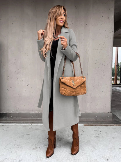 Light gray shawl collar coat worn open with brown boots