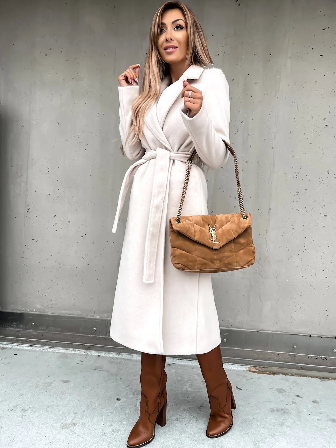 White belted shawl collar coat worn with brown boots