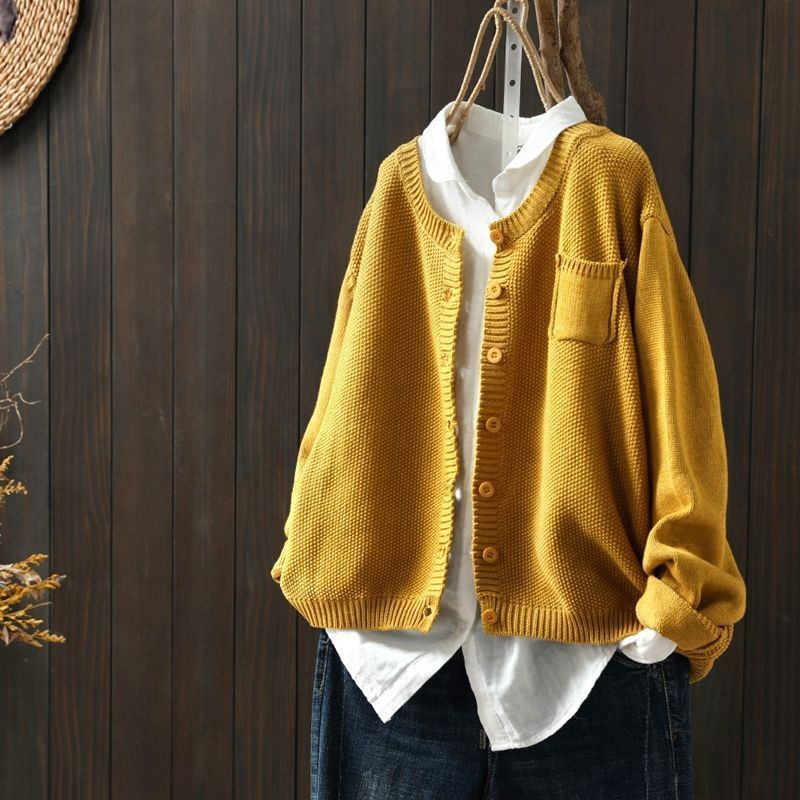 Mustard oversized crew neck cardigan over a white shirt, hanging