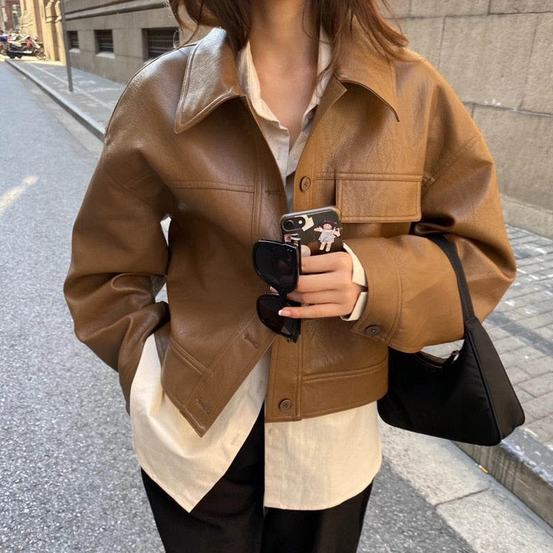Brown boxy faux leather jacket worn over a shirt