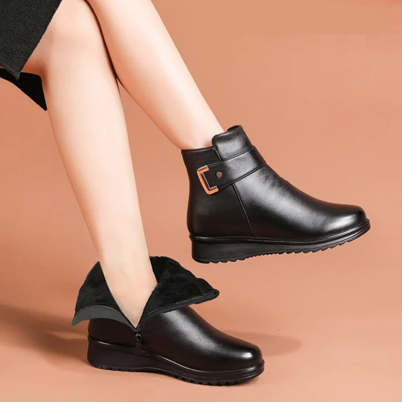 Black buckle strap ankle boots worn on model, one shaft folded to show the lining