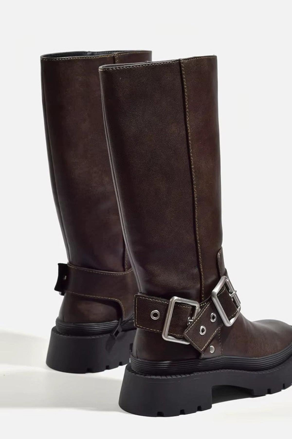 Brown biker boots from behind, showing the buckled ankle straps and chunky sole
