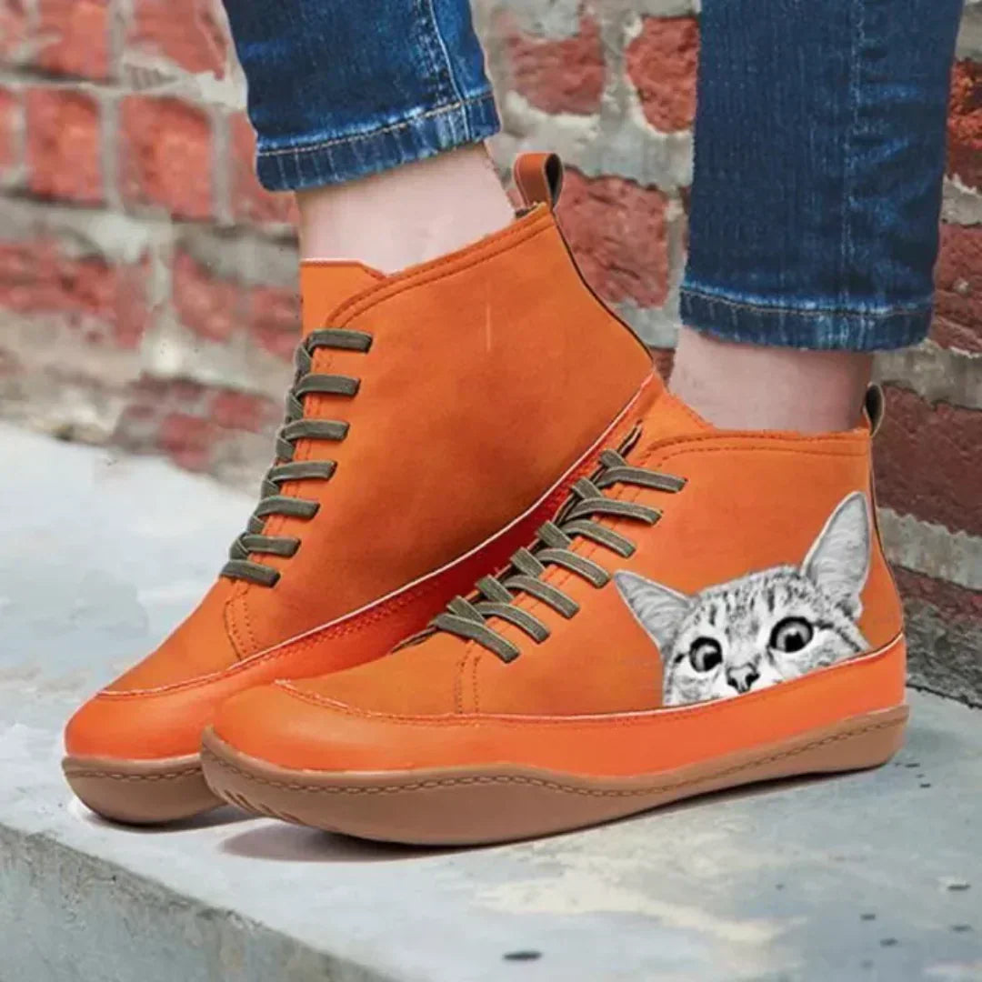 Orange cat print ankle boots worn with jeans