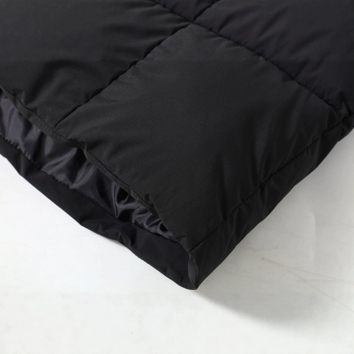 Close up of the black parka hem and quilted padding