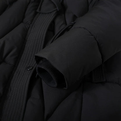 Close up of the black parka zip, drawstring and ribbed inner cuff
