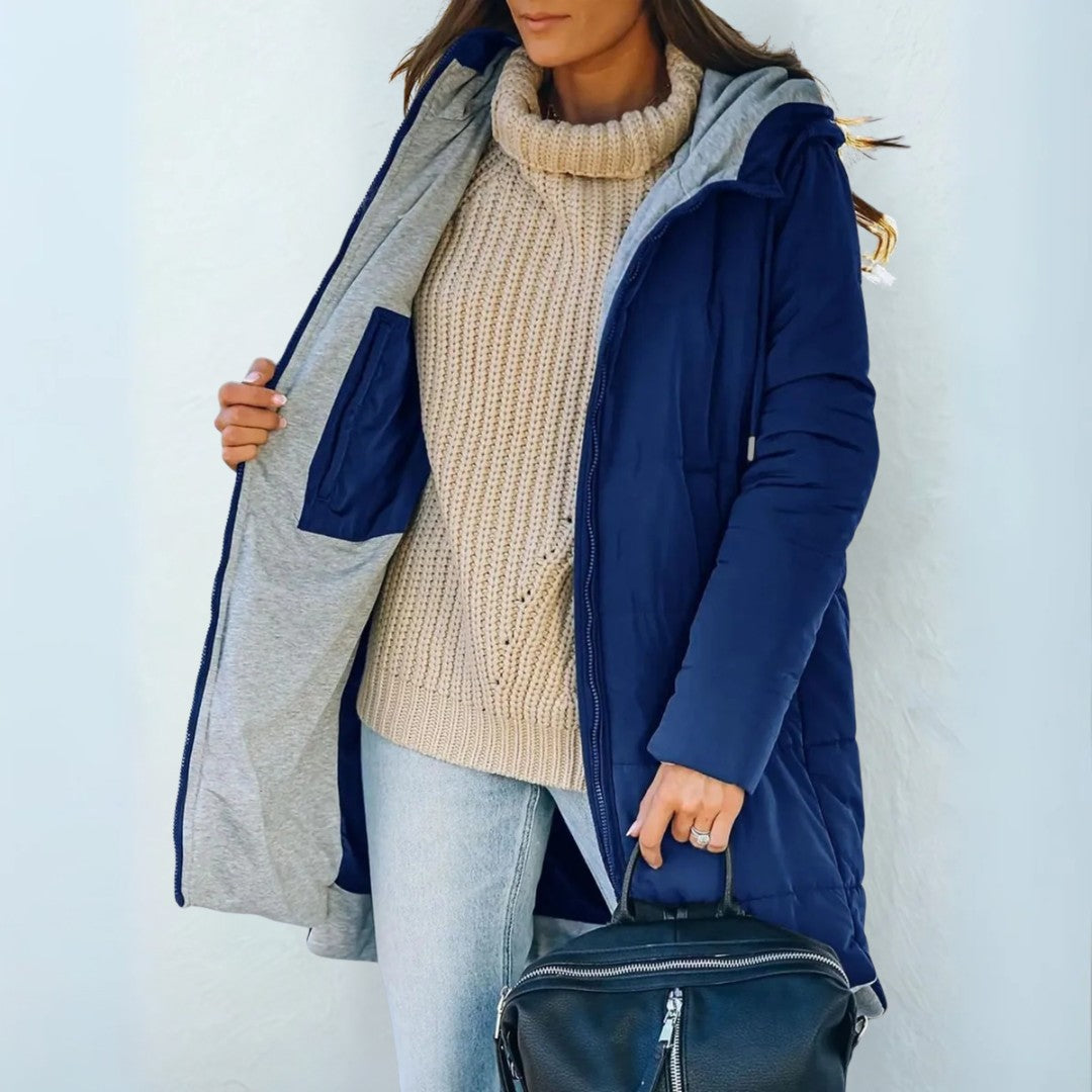 Royal blue quilted coat held open to show the contrast lining