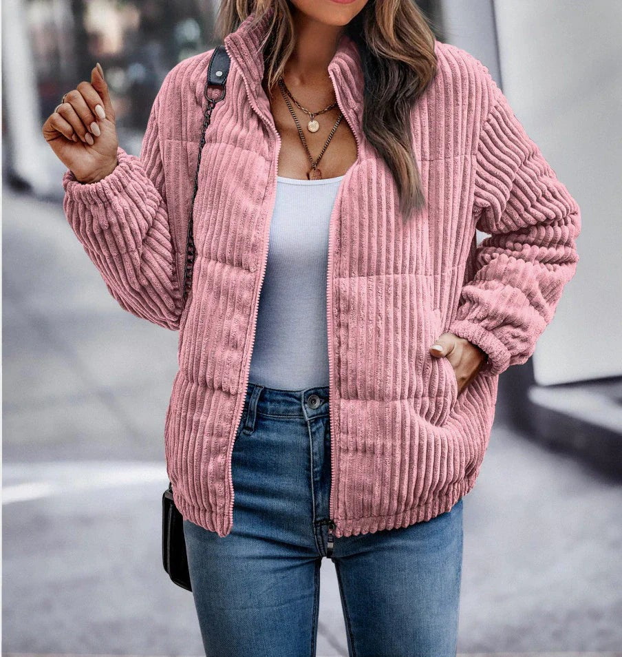 Pink corduroy look puffer jacket worn open over a tank top