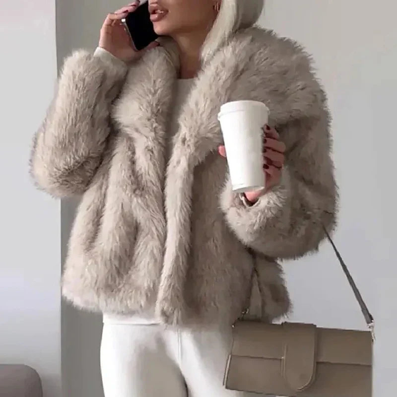 Taupe faux fur jacket worn with white pants