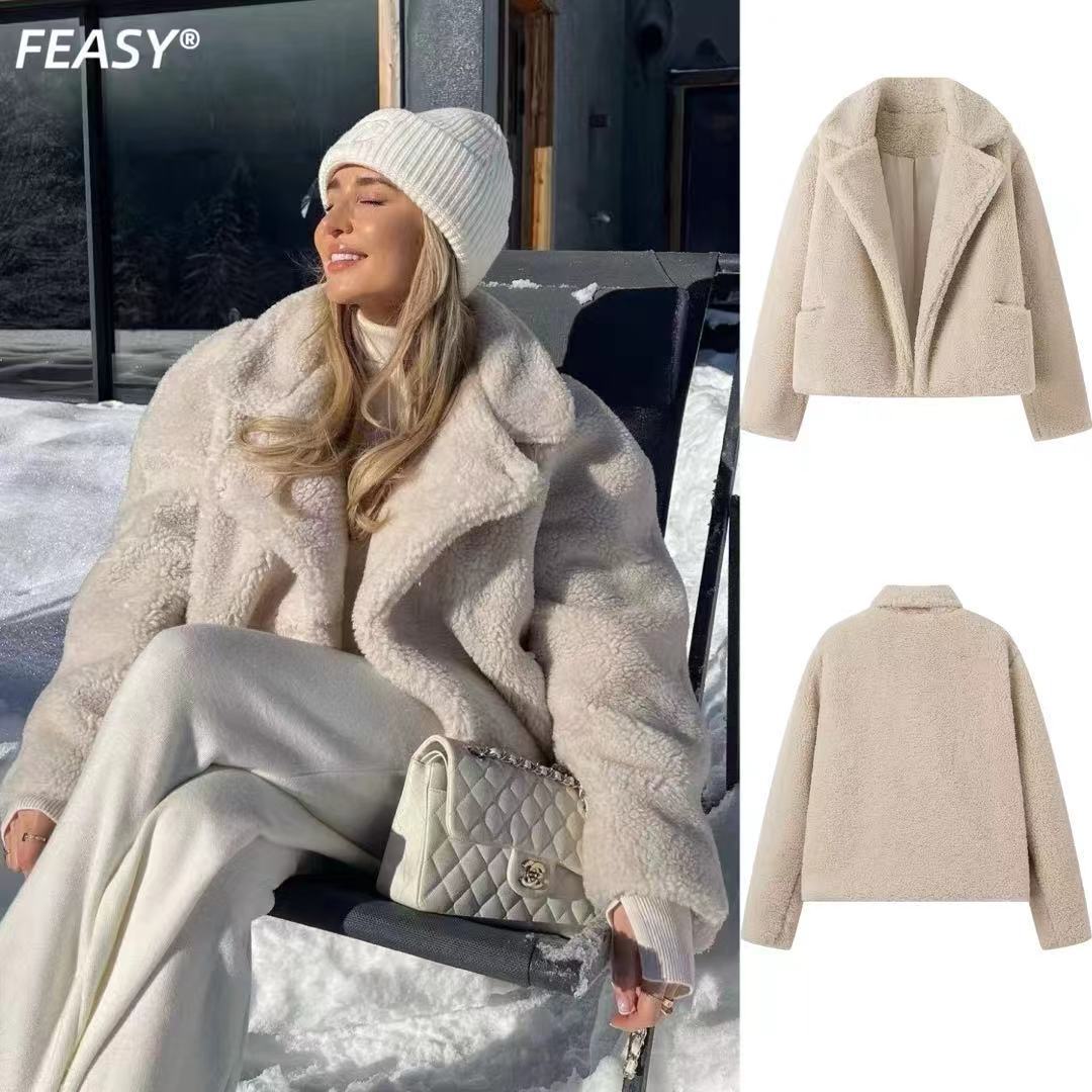 Beige cropped teddy jacket worn with cream pants in the snow