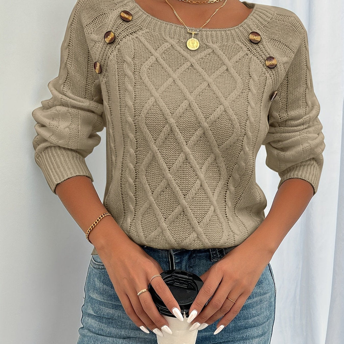Khaki cable knit sweater with button trim worn with jeans