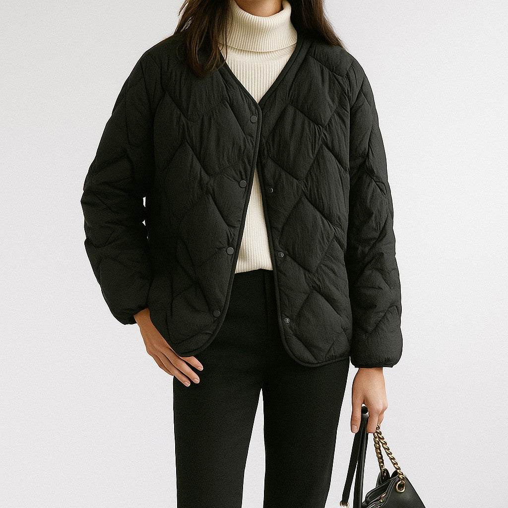 Black diamond quilted V-neck jacket worn, front