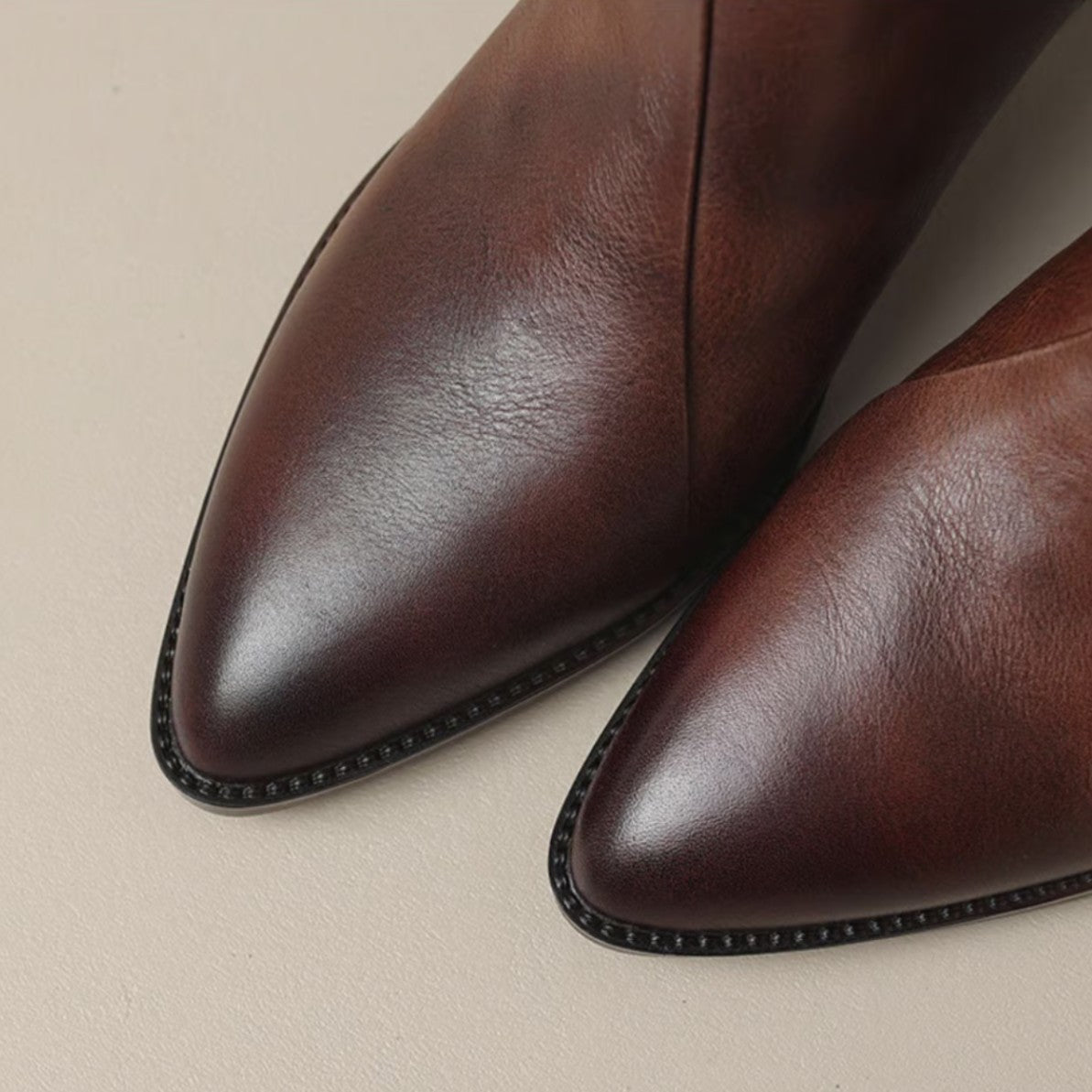 Close up of the wine boot pointed toes and welt edging