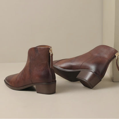 Pair of wine ankle boots showing back zip and block heel