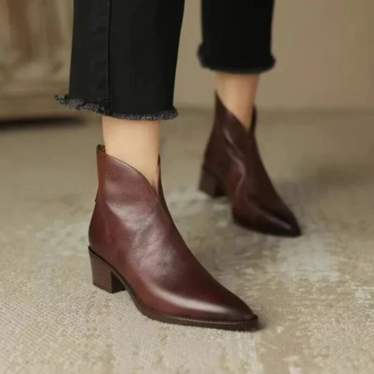Wine V cut ankle boots worn with cropped black pants
