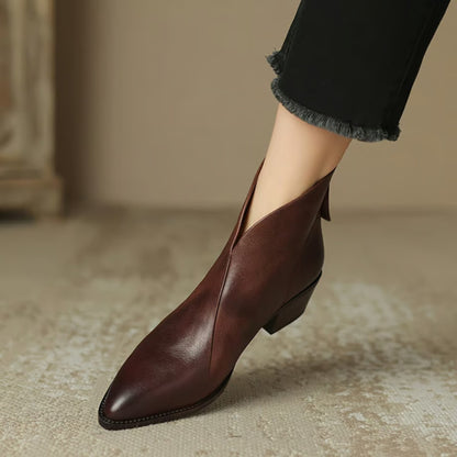 Wine V cut ankle boot on foot, side view of the low heel