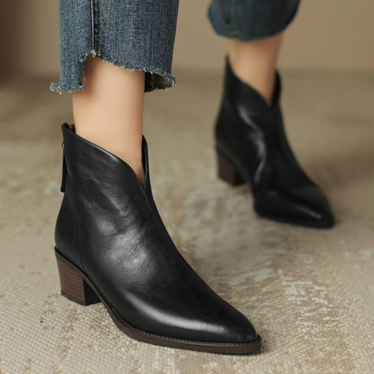 Black V cut ankle boots worn with cropped jeans