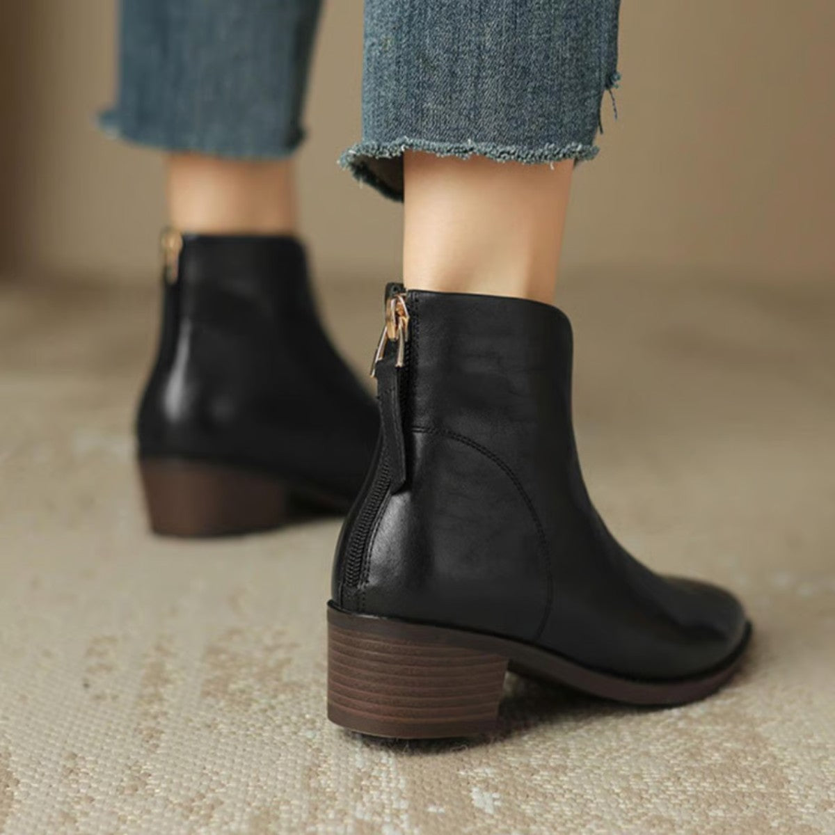 Black ankle boots from behind showing the back zips