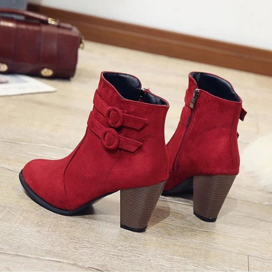 Red ankle boots with two buckled straps and stacked block heel, back view