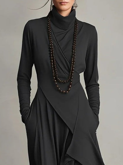 Close up of the charcoal draped neck maxi dress with bead necklaces