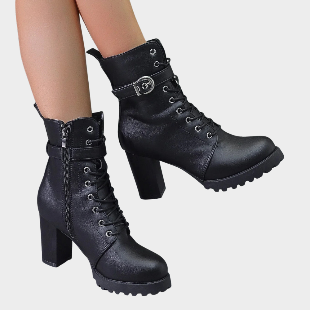 Black combat boots with a buckle strap and lug sole
