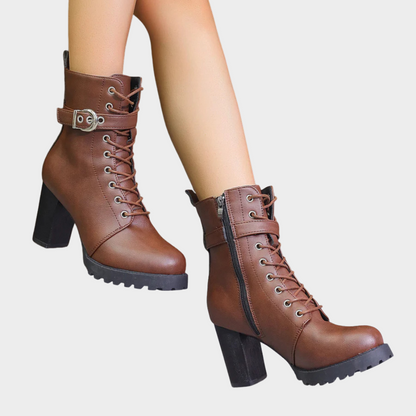 Brown lace up combat boots with a side zip, walking view