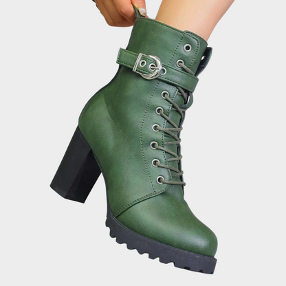 Green lace up combat boot with a buckle strap, side view