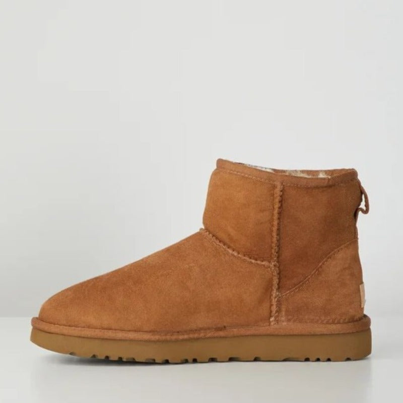 Side view of a camel suede fleece lined ankle boot