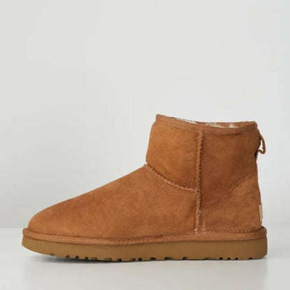 Side view of a camel suede fleece lined ankle boot