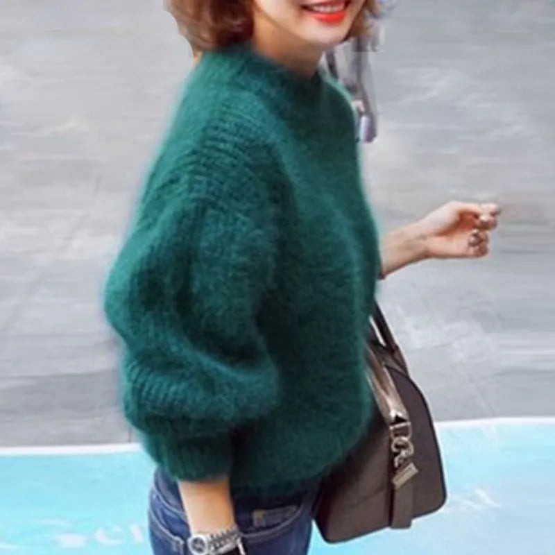 Dark green fluffy balloon sleeve sweater worn with jeans outdoors