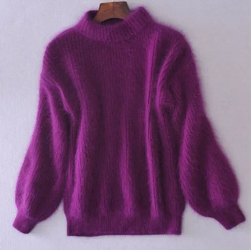 Purple fluffy knit sweater with ribbed cuffs on a hanger