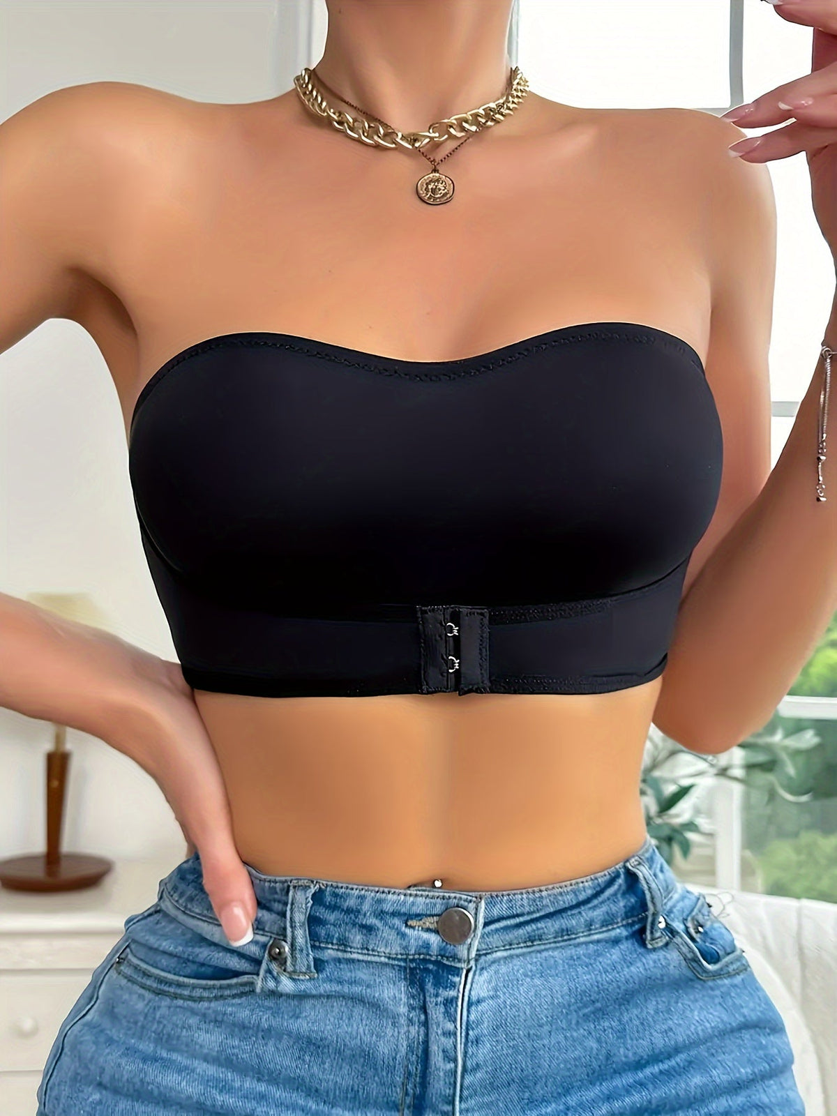 Black strapless bandeau bra worn with jeans