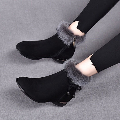 Black fur cuff booties with side bow, worn with leggings