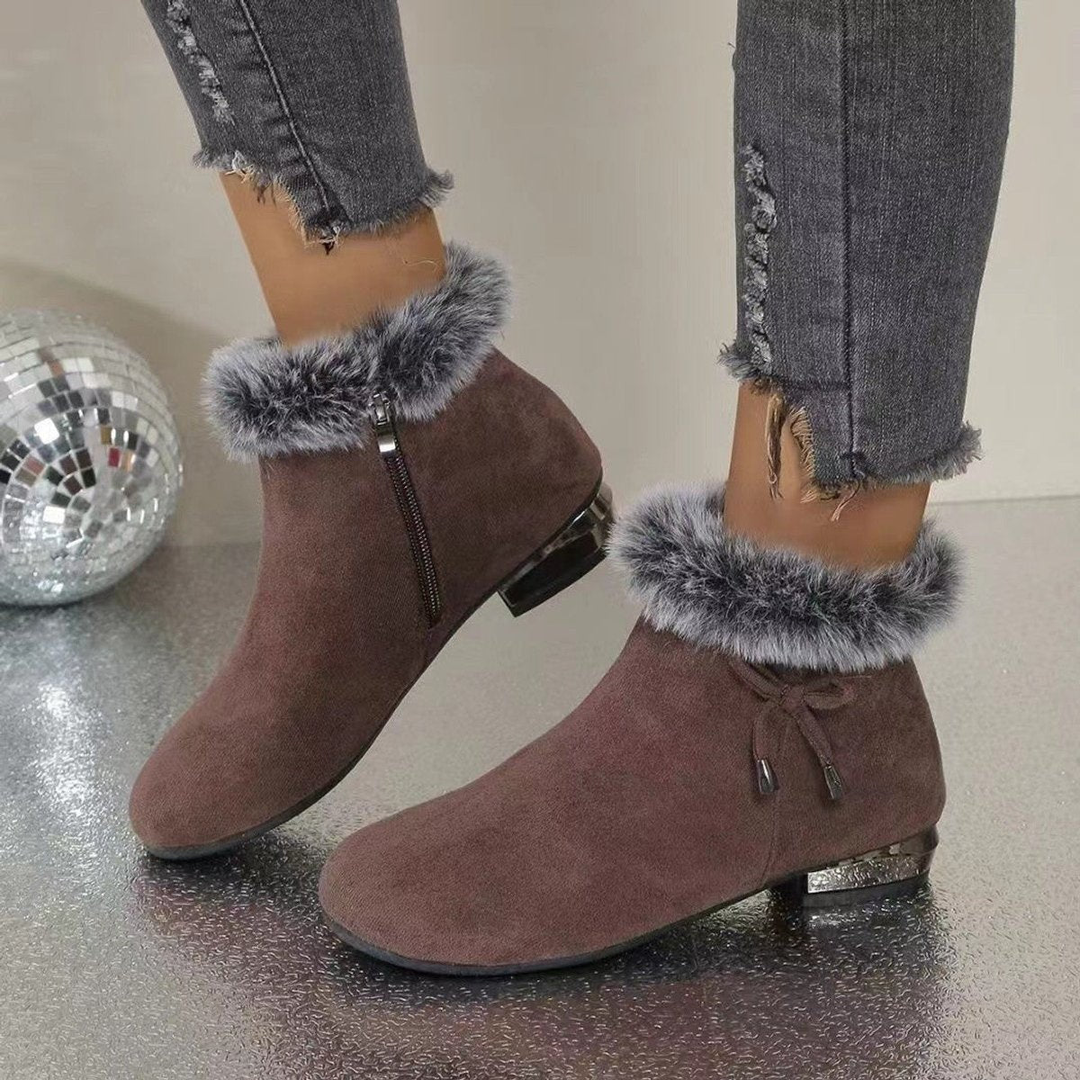 Brown suede booties with faux fur cuff and side zip, worn