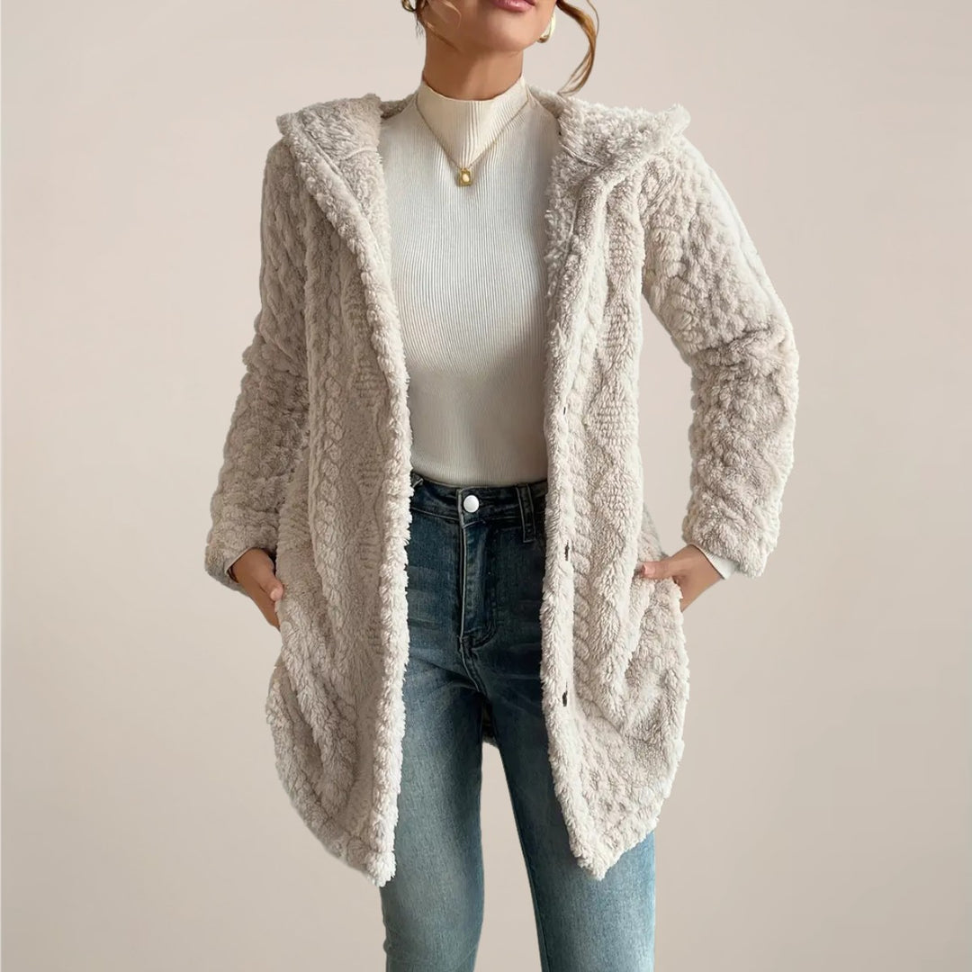 Beige hooded cable knit cardigan worn with jeans