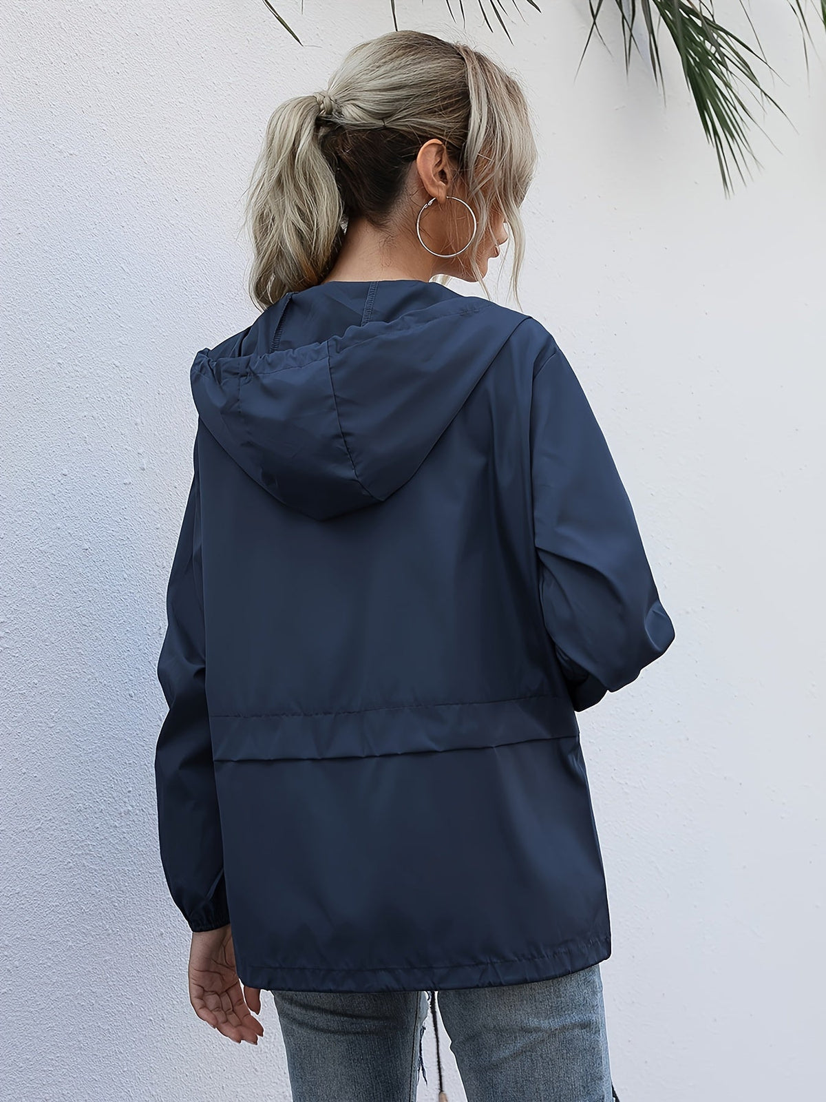 Back view of the navy hooded windbreaker