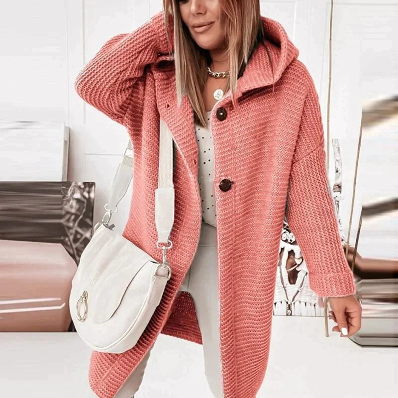 Coral hooded longline cardigan worn with white pants, front view