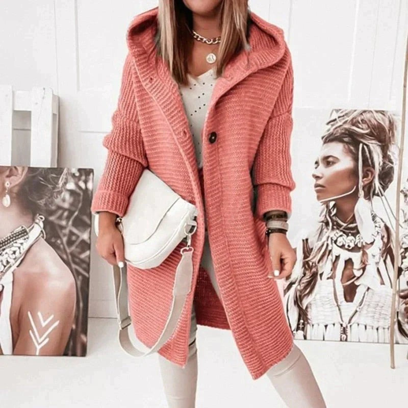 Coral chunky rib knit cardigan with hood, worn with a white bag