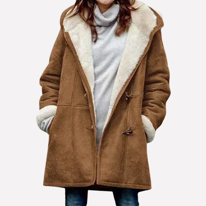 Brown hooded toggle front coat worn open over a gray top